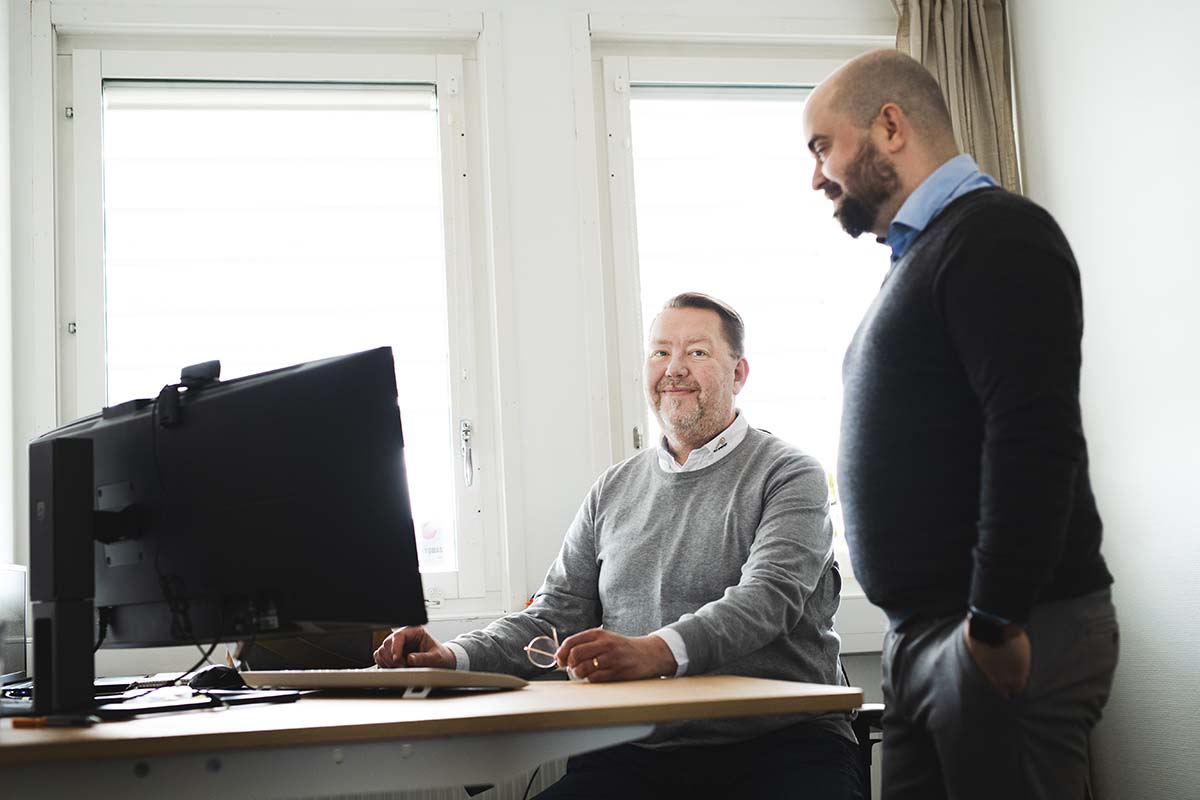 Two middle aged male colleagues in an office